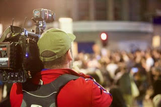 Safety advisor supporting a camera team in a crowd